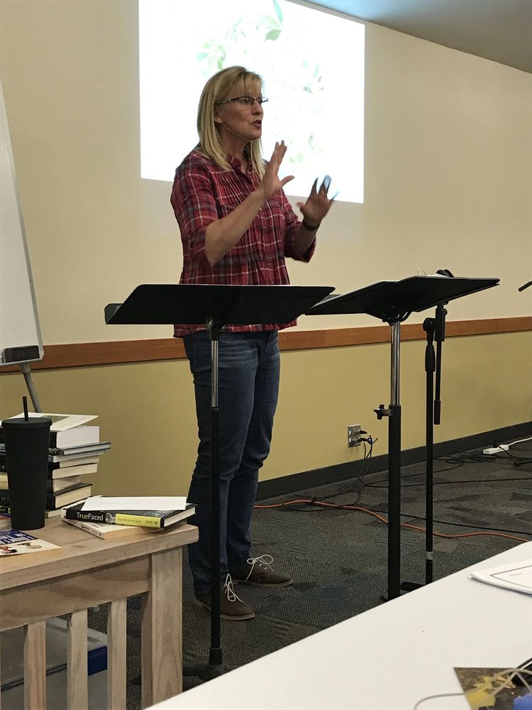 Robin teaching at a music stand in front of a projected slide